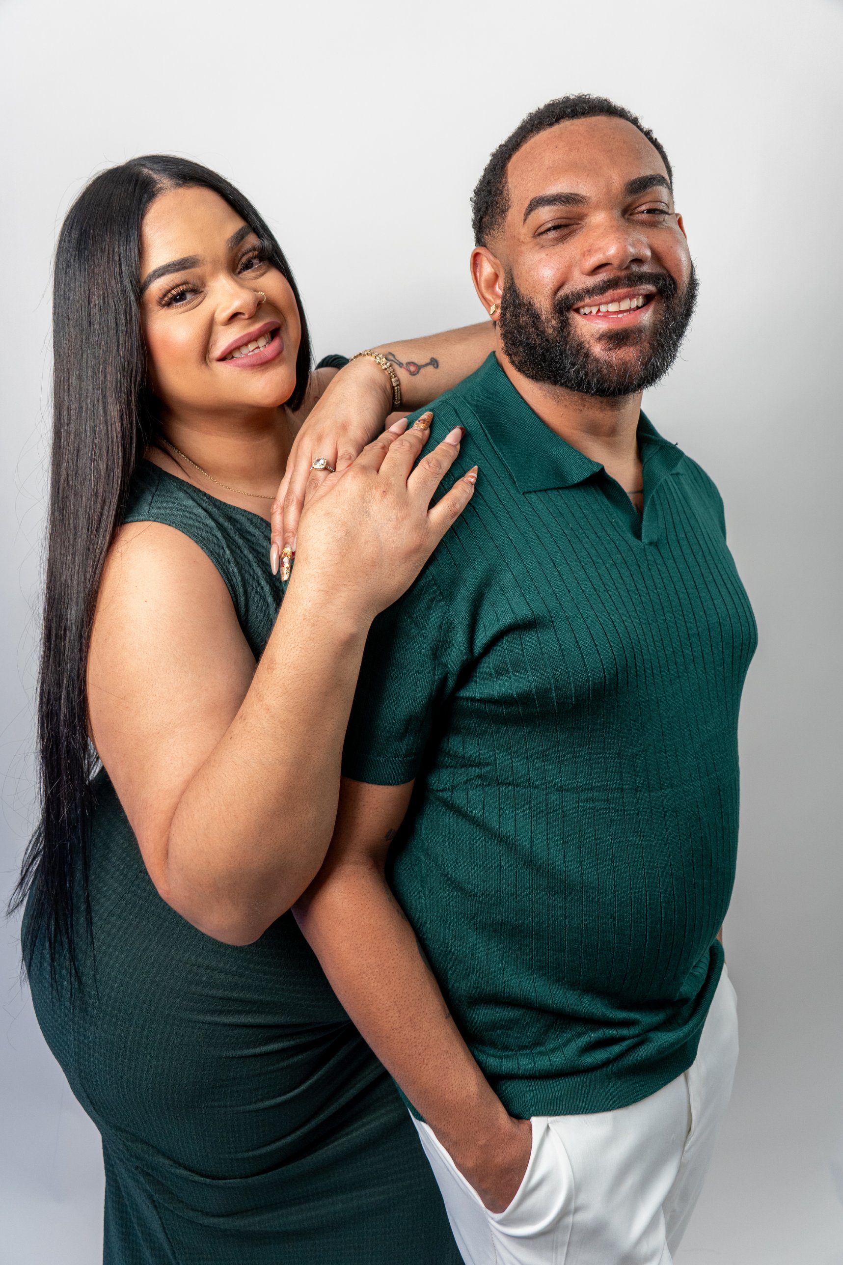 Couple in green, smiling together