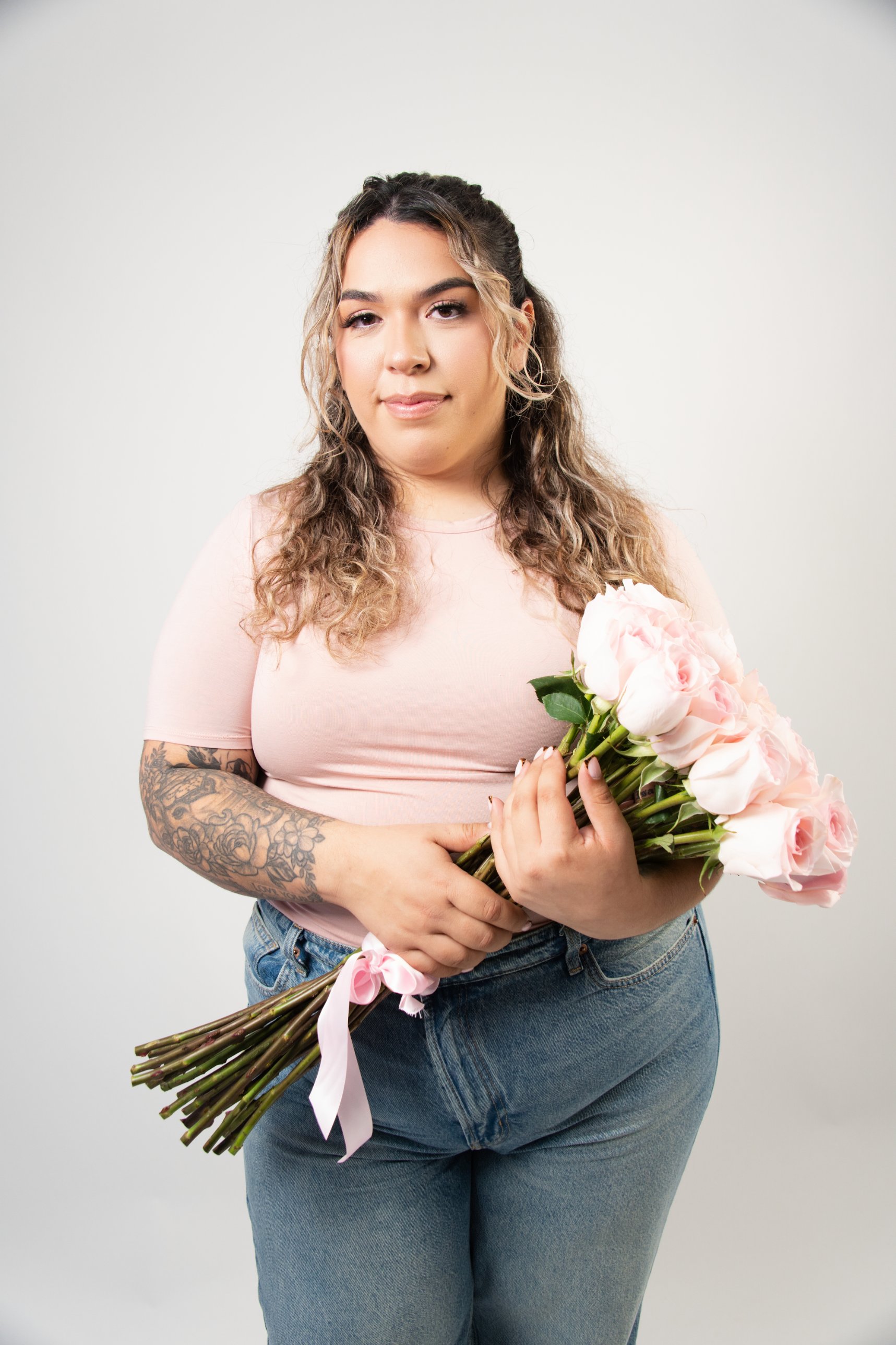 Studio portrait holding pink roses
