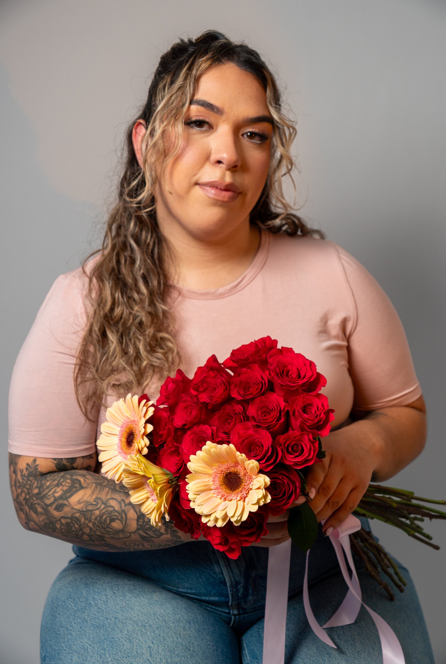 Studio portrait with red roses and gerberas