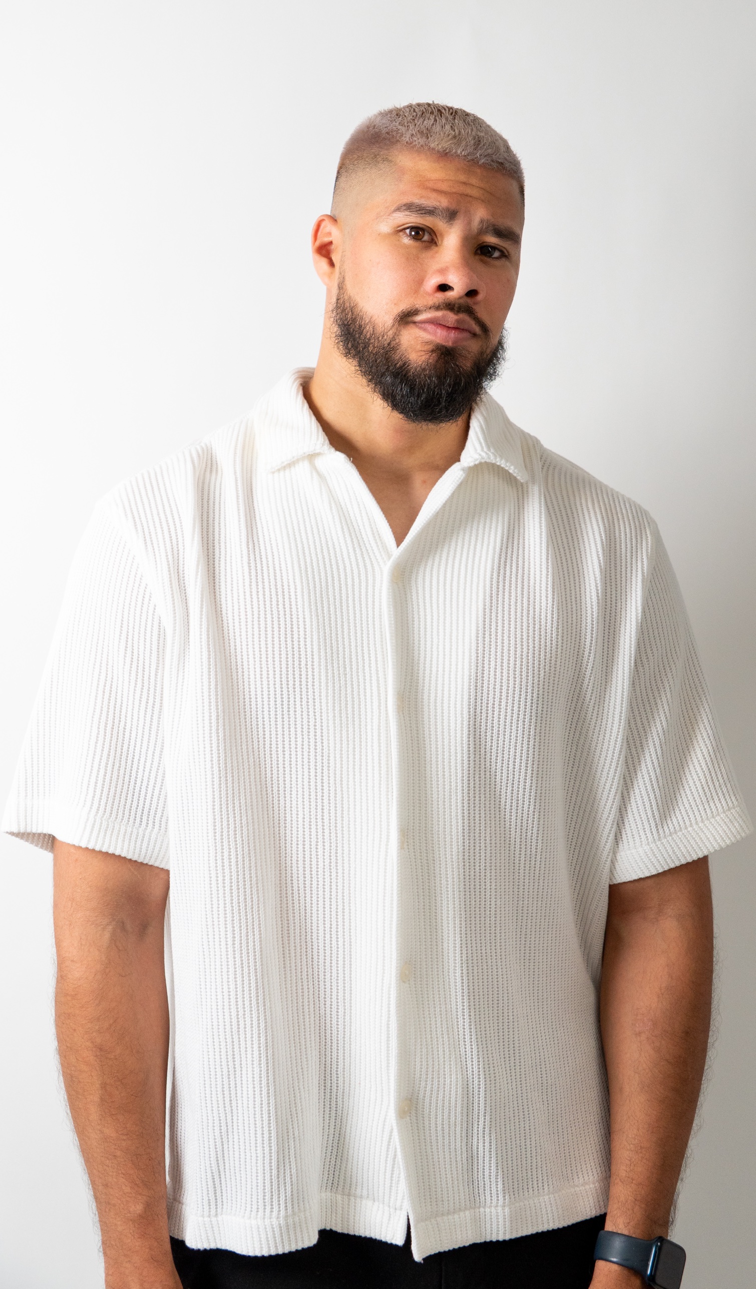 Studio portrait in a white textured shirt